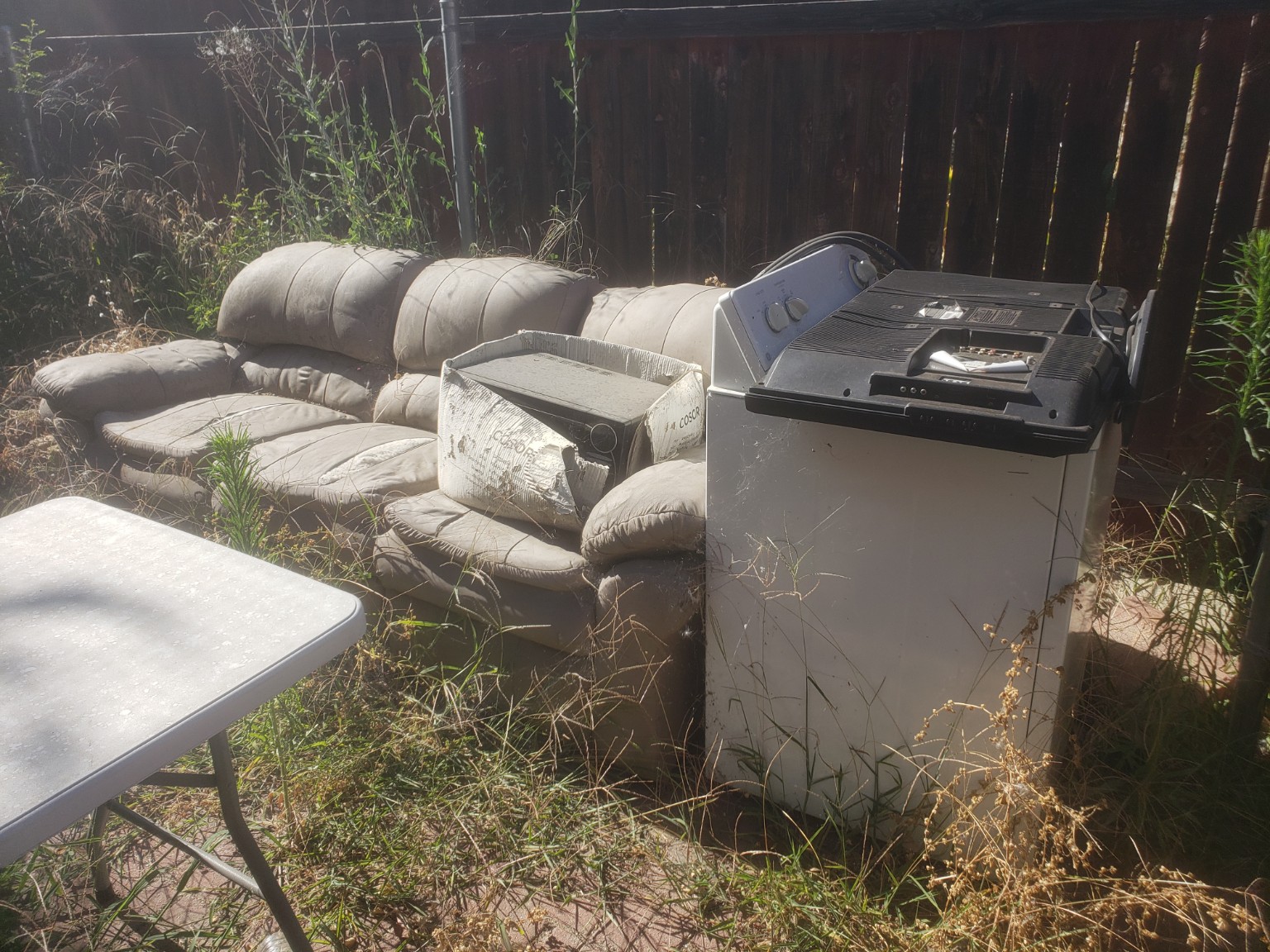 Couch and appliance ready for junk removal